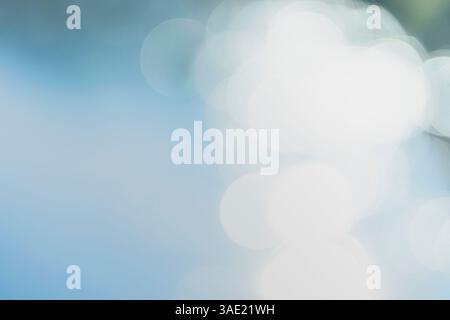 Image shows large, bright, circular light shapes blurred against a gradient background of white and light blue-gray Stock Photo