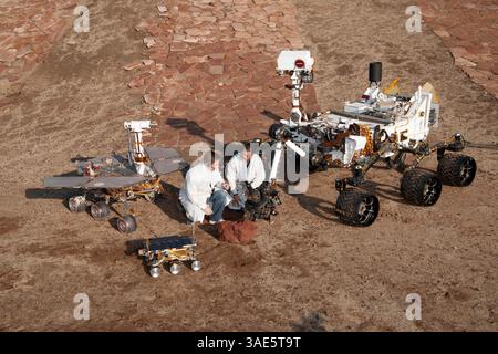 Jan. 19, 2012 - Pasadena, California, U.S. - On Dec. 15, 2011 two spacecraft engineers, JPL's MATT ROBINSON, left, and WESLEY KUYKENDALL, join a grouping of vehicles providing a comparison of three generations of Mars rovers developed at NASA's Jet Propulsion Laboratory, Pasadena, Calif. The setting is JPL's Mars Yard testing area. Front and center is the flight spare for the first Mars rover, Sojourner, which landed on Mars in 1997 as part of the Mars Pathfinder Project. On the left is a Mars Exploration Rover Project test rover that is a working sibling to Spirit and Opportunity, which lande Stock Photo
