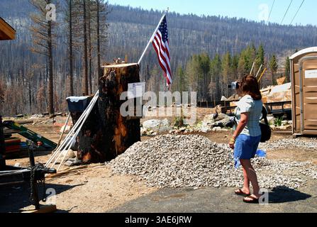 Terry Scales videotapes a sort of memorial in front of a house under ...