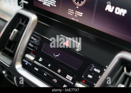 detailed look at a modern vehicle dashboard, featuring a touchscreen infotainment display, hazard button, and climate controls for enhanced driver con Stock Photo