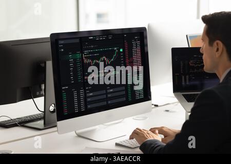 Male financial broker working on Internet stock market, analyzing investment Stock Photo