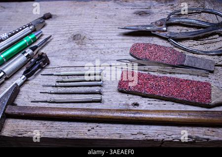 "Vintage Watchmaker’s Tools on Rustic Wooden Table – Legacy of a Master Craftsman" Stock Photo