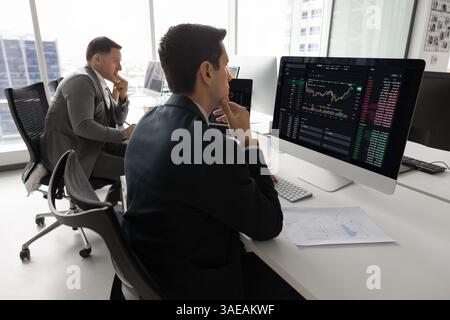 Financial trader man analyzing stock market, thinking on investment Stock Photo