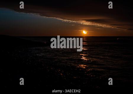 Partial solar eclipse captured at sunrise from Dartmouth, Nova Scotia, Canada. Stock Photo
