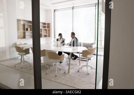 Two workmates working on common task completion using laptop Stock Photo