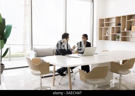 In modern conference room workmates working on common task completion Stock Photo