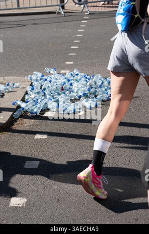 Empty water bottles on the streets of Brighton, England, UK for the 2025 marathon on a sunny day. Stock Photo