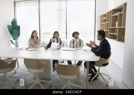 Group of multiracial professionals negotiating in modern office meeting room Stock Photo