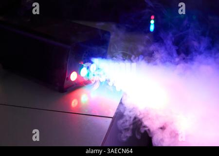 Dramatic blue and magenta hues blend in a ghostly fog, capturing the magic and exhilaration of a nightclub setting, potentially ideal for music festiv Stock Photo