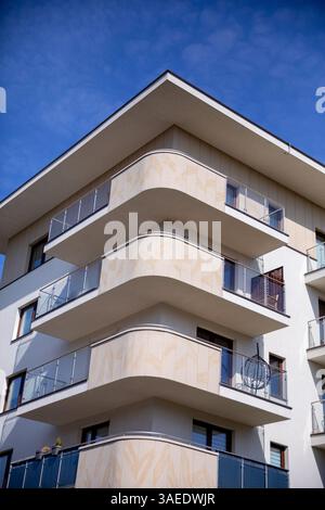 This is a modern apartment building featuring stylish balconies and clean, sleek lines Stock Photo