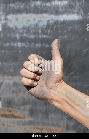 Dirty hand making a thumb. The hand of the worker. Thumbs up Stock Photo