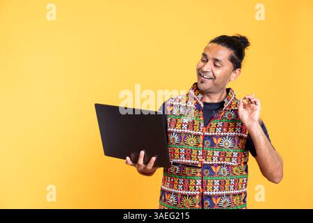 Happy software engineer remotely solving bugs for client over internet videocall on notebook. Cheerful IT technician discussing with customer on online videoconference, studio background Stock Photo
