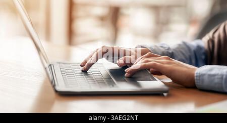 Female hands typing on laptop over blurred background Stock Photo