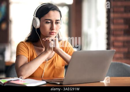 Concentrated young arab lady having educational course online Stock Photo