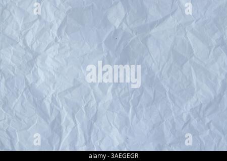 Recycled white crumpled packing paper texture. Black small particles on the white background. Wrinkled wrapping paper. Stock Photo