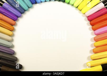 Colored markers placed in a circle on a white background with copy space Stock Photo
