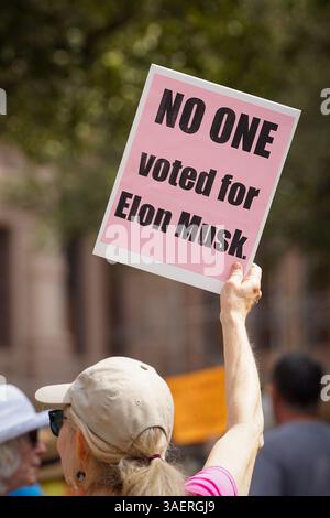 A demonstrator holds a sign reading 