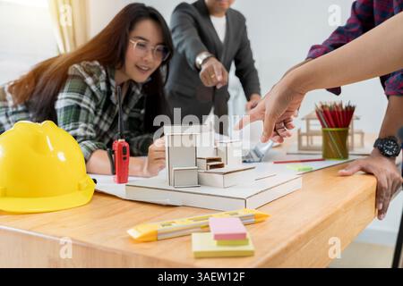 Construction and structure concept of Engineer or architect meeting for project working with partner and engineering tools on model building and bluep Stock Photo