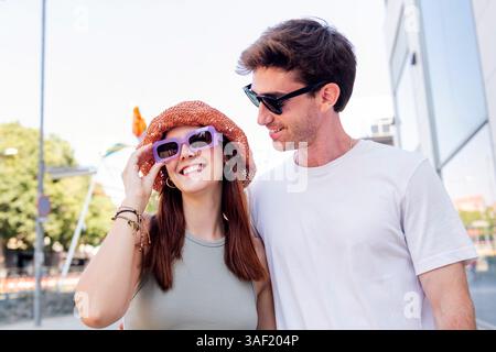 young couple smiling happy during a romantic walk Stock Photo