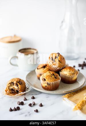 Chocolate Chip Cream Cheese Muffins on a Plate with Coffee mug Stock Photo