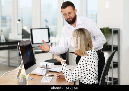 Technicians making digital engineering drawing on computer at desk in office Stock Photo