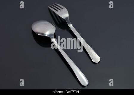Close-Up of Metal Fork and Spoon on Black Surface Stock Photo
