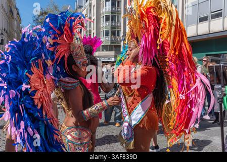 Two women with beautiful feather costumes preparing themselves for the carnival parade in Paris Stock Photo