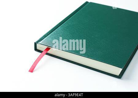 Book with red ribbon bookmark on white table, closeup Stock Photo