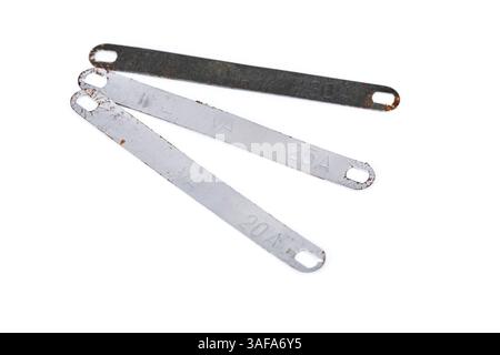 Flat fuse supports various electric currents. Some parts are rusted and should not be used. They are on a white background. Stock Photo