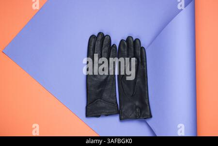 Leather gloves on folded paper background. Minimalistic fashion still life. Flat lay. Top view Stock Photo