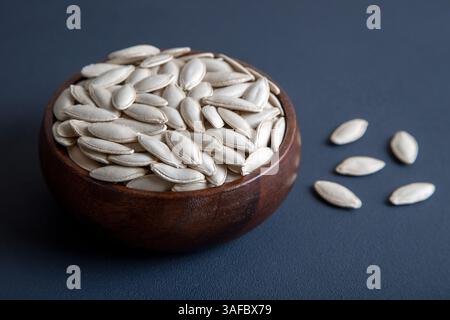 A bowl full of pumpkin seeds,on dark background,top view Stock Photo