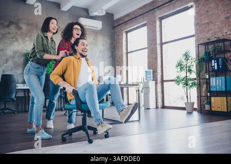 Group of Young Colleagues Enjoying a Fun Moment in a Vibrant Modern Office Environment Stock Photo