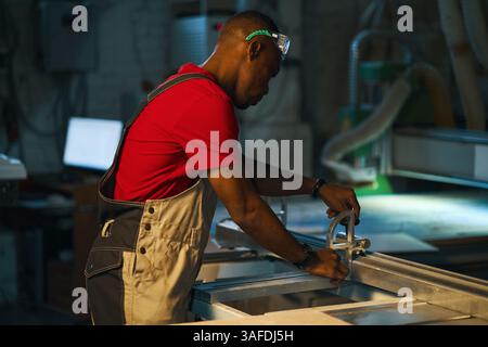 Workman Working On Lathe In Factory Stock Photo