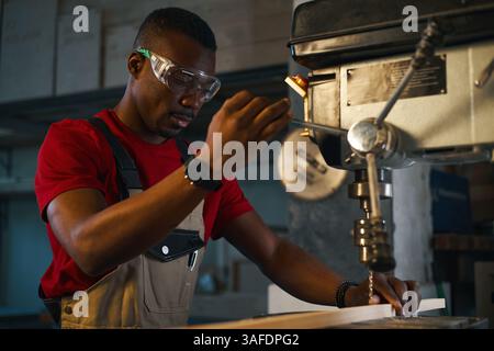 Worker Working On Lathe In Factory Stock Photo