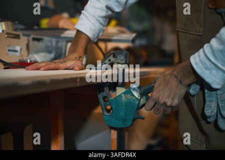 Female Worker Working With Tool In Workshop Stock Photo