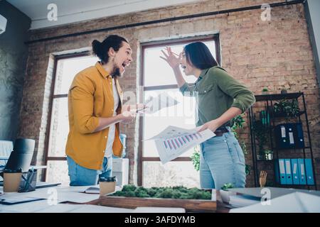 Colleagues Celebrating Successful Project Completion with Enthusiasm in a Bright Modern Office Stock Photo