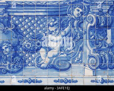Fragment of exterior facade. Chapel of Souls. Church is covered with blue and white azulejo tiles, with scenes from the lives of saints and angels. Stock Photo