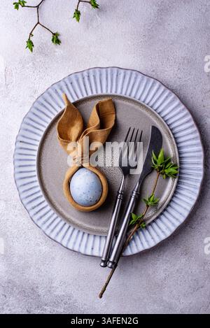 Elegant Easter table setting with painted egg Stock Photo