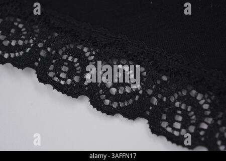Black, gray, dark beautiful lace from flower buds, blossoming roses, peonies. Unusual fabric, lace with a sheen imposed on black fabric made of natura Stock Photo