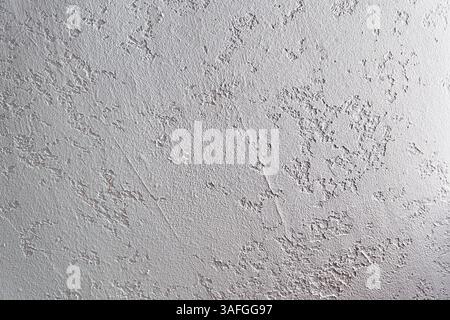 White plastered wall. Uneven background with the texture of decorative plaster painted in white concrete wall. Rough wall with space for copying. High quality photo Stock Photo