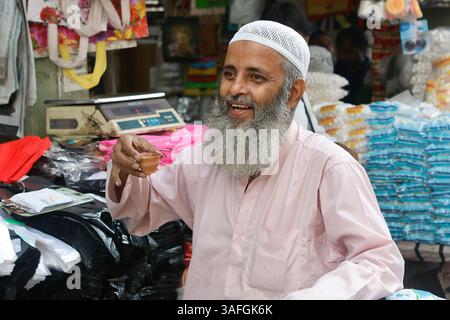 Muslim man drinking tea from a clay cup in Kolkata, West Bengal, India Stock Photo