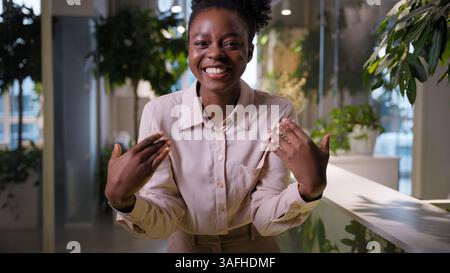 Happy woman African American ethnic cheerful girl businesswoman employer leader toothy smiling business worker manager welcome gesture tempting come Stock Photo