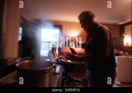 Rev. Ted Hoskins pulls a freshly cooked lobster out of a pot to serve to a friend in the parsonage on Isle Au Haut, Maine. Hoskins is curtailing his ministry duties with the Maine Sea Coast Missionary, and becoming more of an advocate to the are fisherman. Tuesday, September 3, 2002 (Credit Image: The Washington Times/ZUMAPRESS.com) Stock Photo