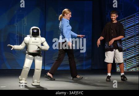 Chris Harris, 12, tries to mimick the dance moves of ASIMO, a humanoid robot, Monday, September 8, 2003. In the middle, host Shari Rose judges the competition. ASIMO, which stands for, Advance Step in Innovative Mobility, is the product of research by Honda and was giving demonstrations at the Washington Convention Center. (Credit Image: The Washington Times/ZUMAPRESS.com) Stock Photo