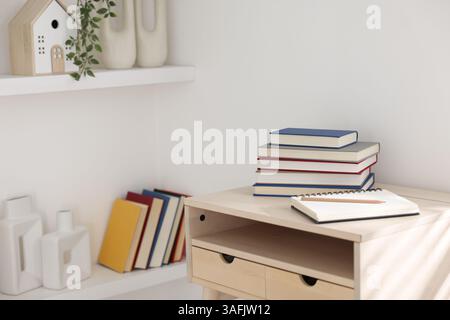 Books, notebook and pencil on wooden table indoors Stock Photo
