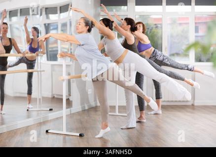 Group of women beginners practicing at ballet barre Stock Photo