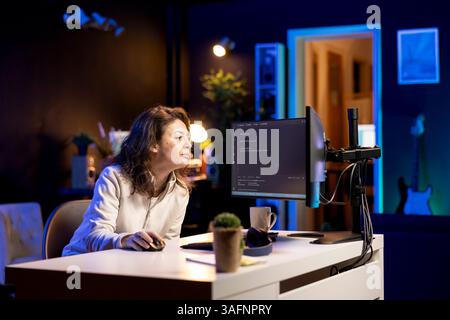 Developer typing code on computer to futureproof company network from downtimes and unexpected system failures. Woman deploying programming script increasing data security on desktop PC Stock Photo