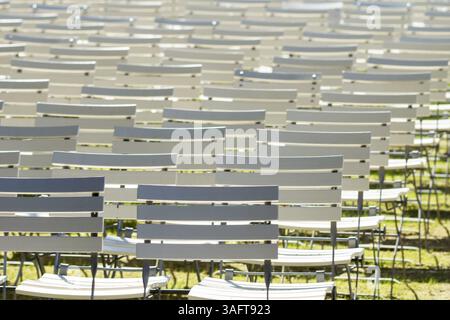 White rows of chairs in a dark spa park Stock Photo