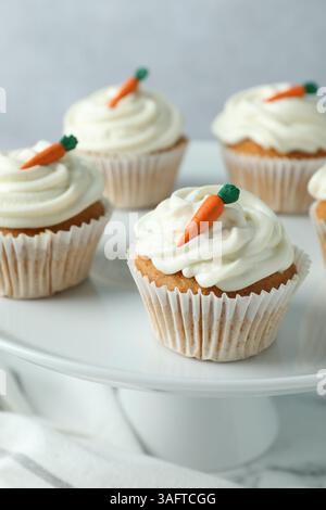 Delicious carrot cupcakes on table against grey background, closeup Stock Photo