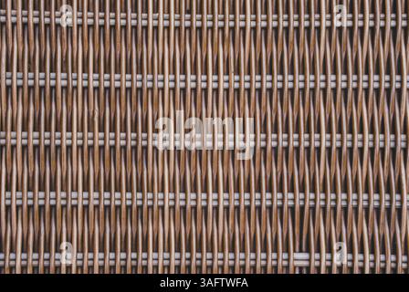 A detailed close-up of a brown woven rattan texture, ideal for backgrounds or illustrating natural materials. Stock Photo